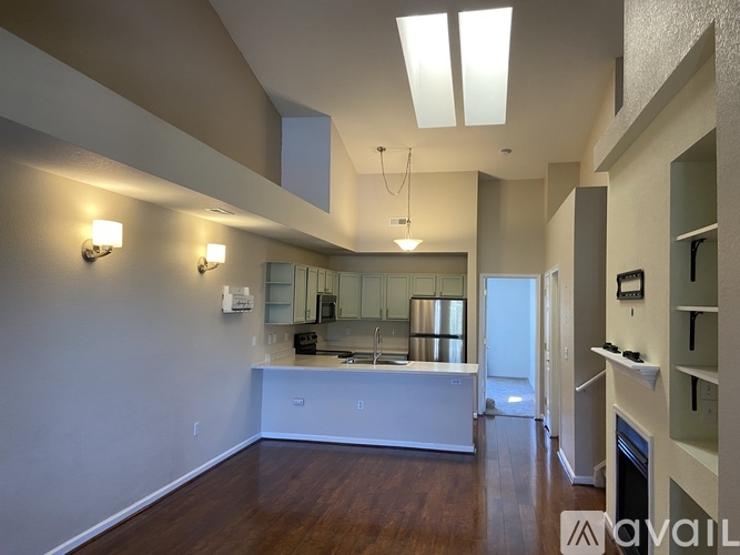 A spacious kitchen with a white island and wooden floors.