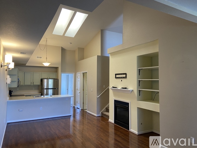 A spacious living room with a fireplace and built-in shelves.