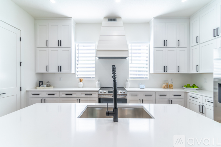 A modern kitchen with white cabinets and a central island.