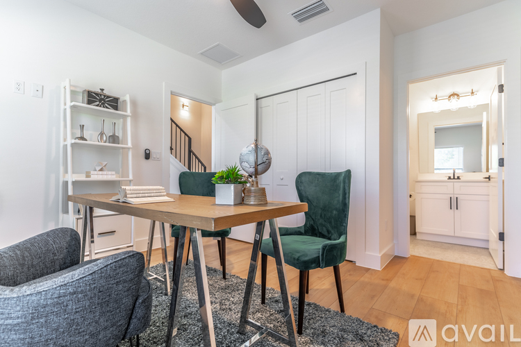 A dining room with a table and chairs.