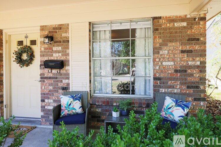 A house with a white door and a wreath on it.
