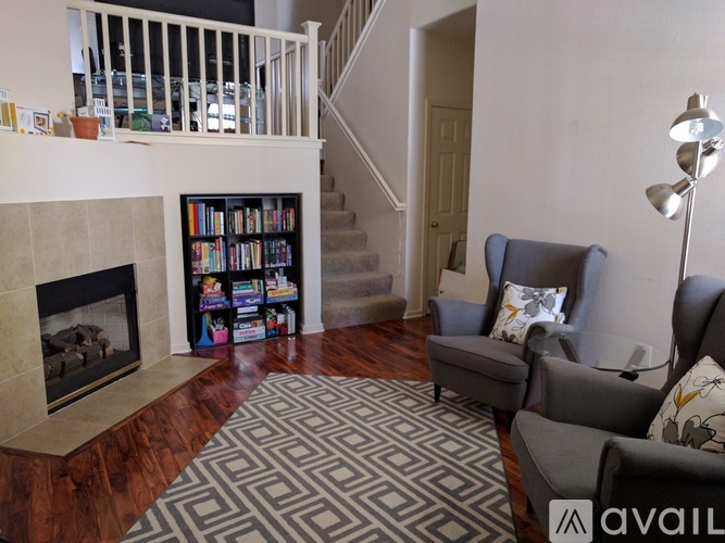 A living room with a fireplace and a bookshelf.