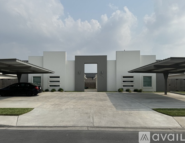 A modern house with a black car parked in front.