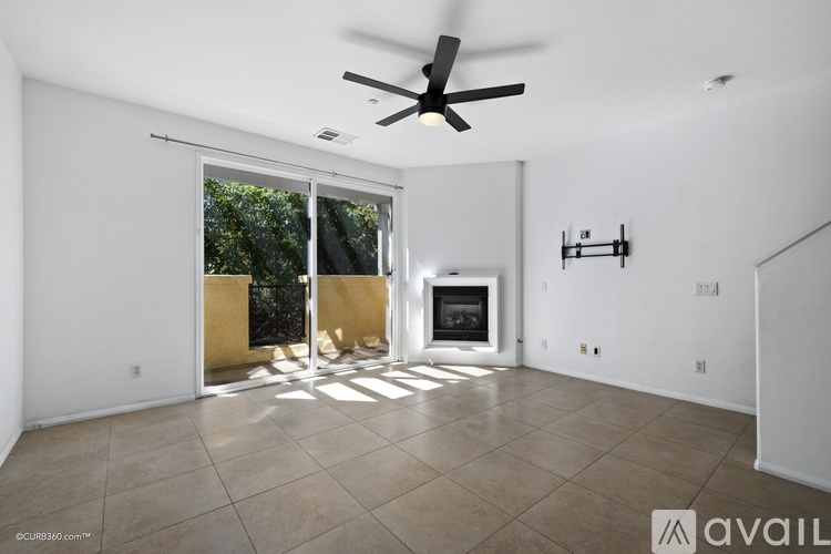A spacious living room with a fireplace and sliding glass doors.