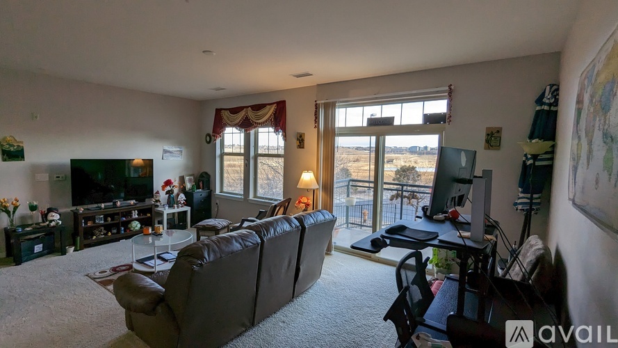 A living room with a brown couch and a television.
