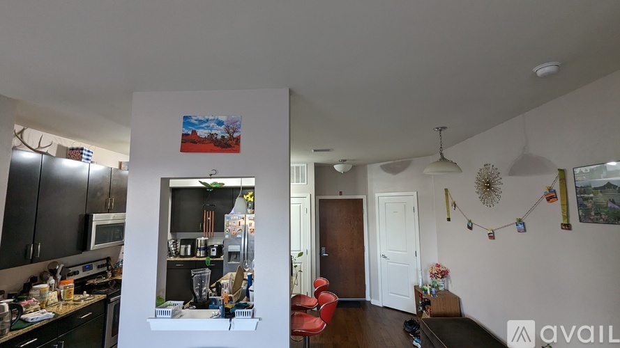 A kitchen with a dining table and chairs in the middle of the room.