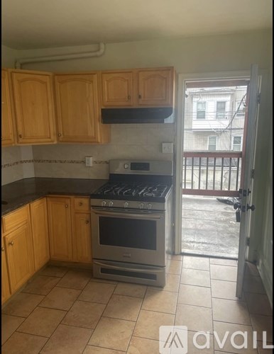 A kitchen with wooden cabinets and a stainless steel oven.