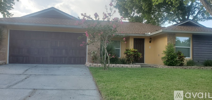 A house with a brown garage door and a brown roof.