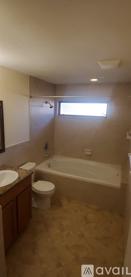 A bathroom with a toilet, sink, and bathtub.