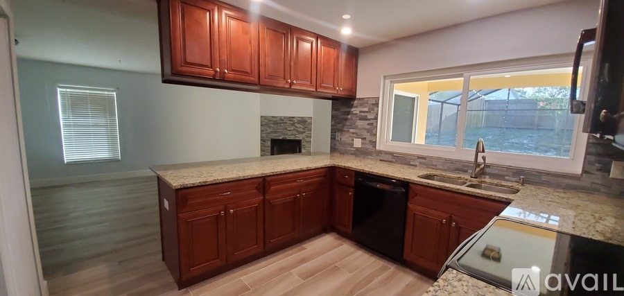 A kitchen with wooden cabinets and granite countertops.