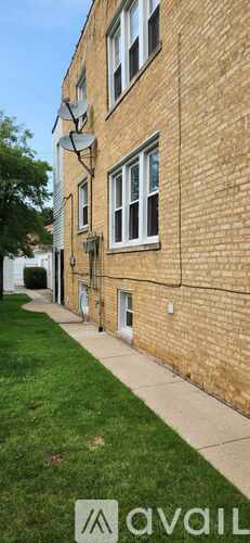 A brick building with a green lawn in front.