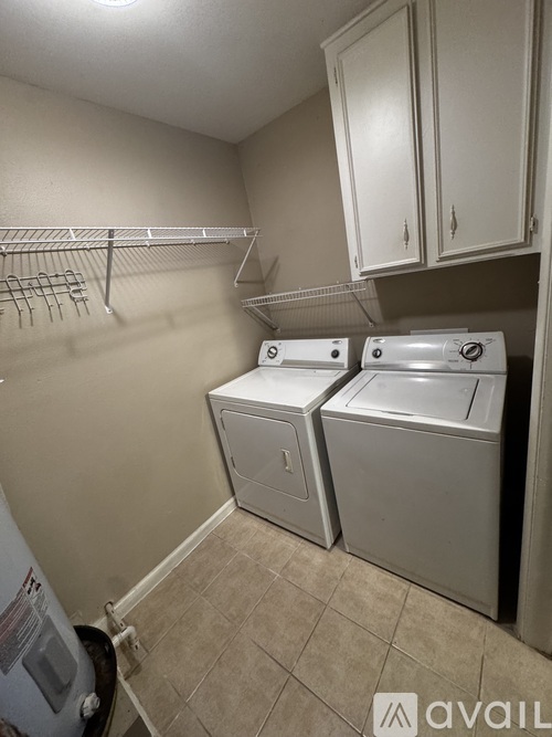 A small laundry room with a washer and dryer.