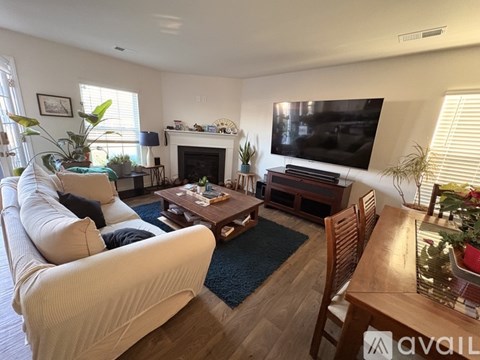 Empty room with a white wall and a brown floor.