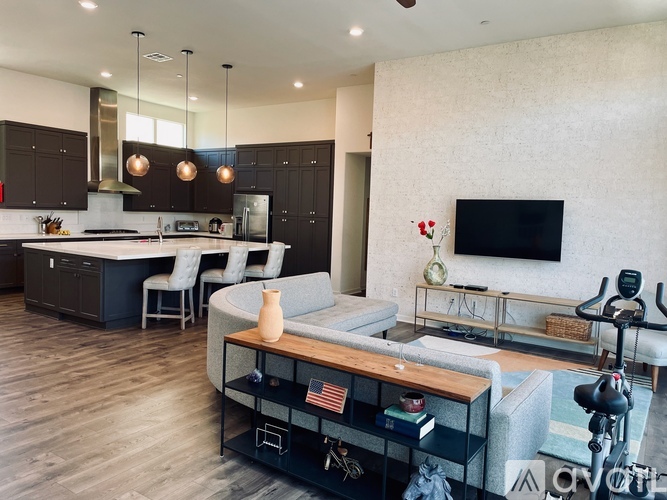 A modern kitchen with dark brown cabinets and a wooden island.
