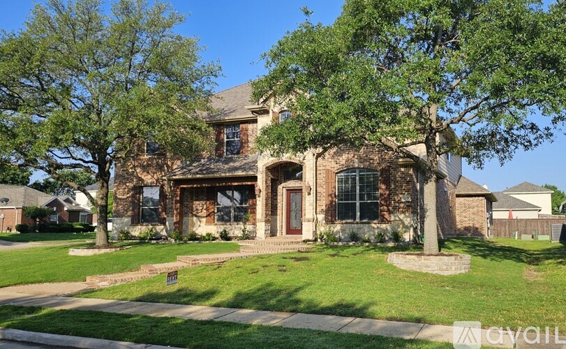 A house with a front yard and a tree.
