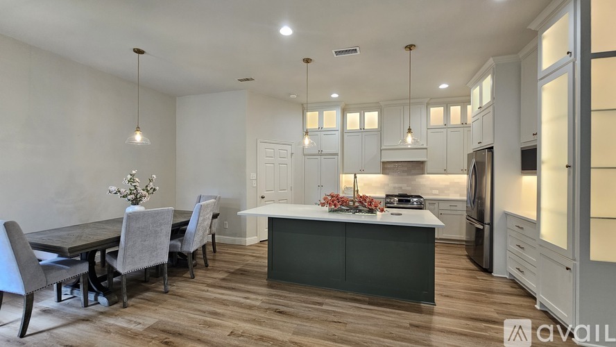 A modern kitchen with a dining table and chairs.