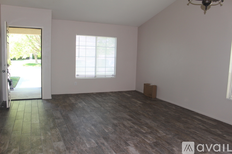 A room with a window and a door leading outside.