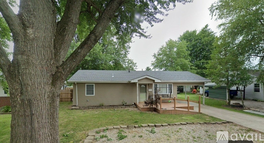 A house with a tree in front of it.