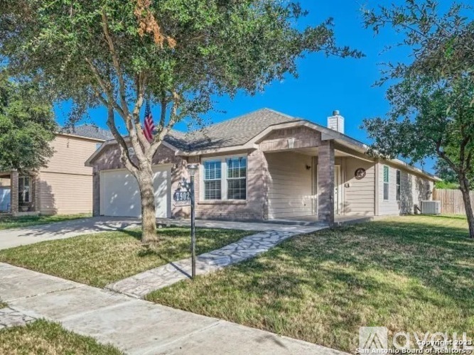 A house with a tree in front of it.