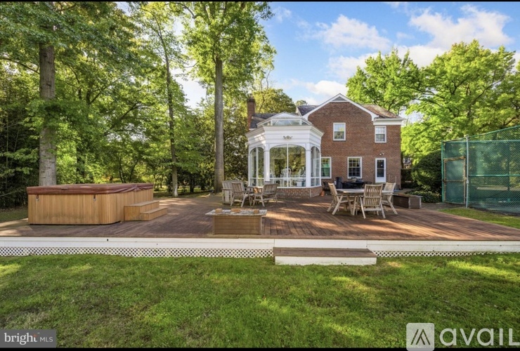 A house with a pool and a gazebo in the backyard.
