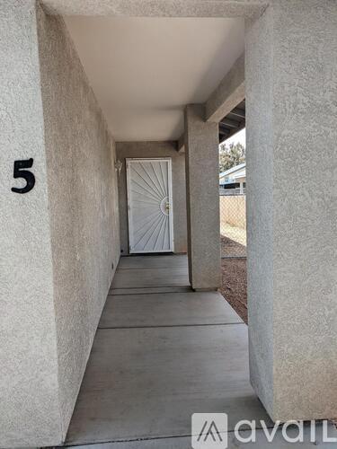 A hallway with a door and a number 5 on the wall.