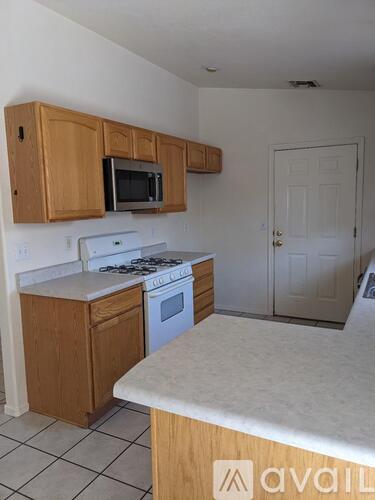A kitchen with wooden cabinets and a white countertop.
