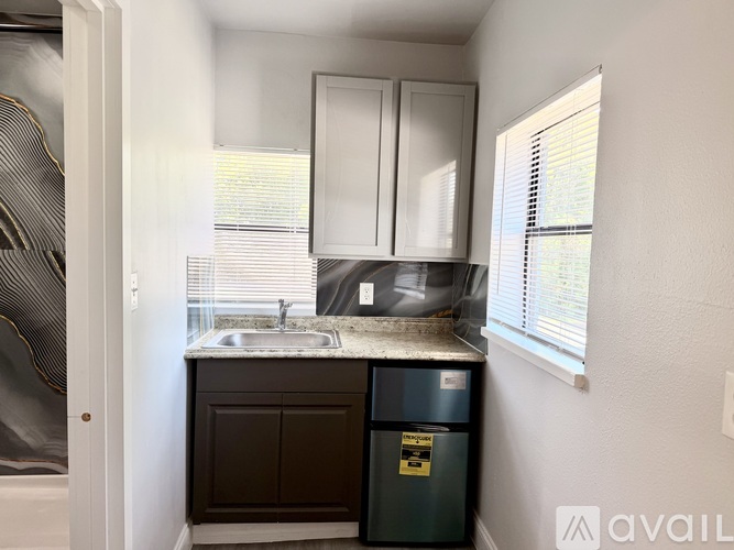 A small bathroom with a sink and a trash bin.