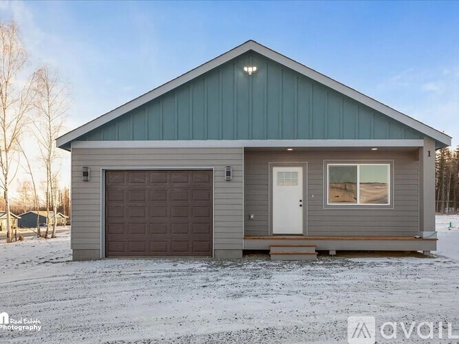 A modern house with a grey garage door and a white door is available for purchase.