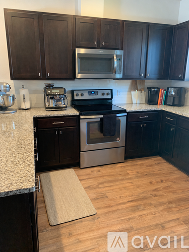 A kitchen with a black oven and black cabinets.