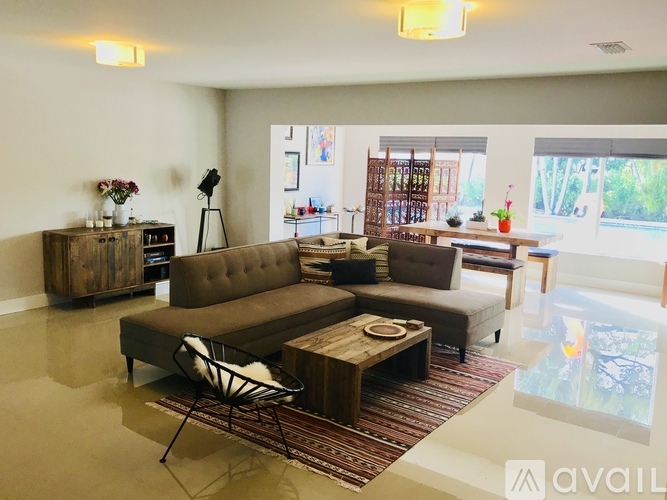 A living room with a brown sofa and a coffee table.