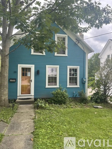 A blue house with a brown door and windows.