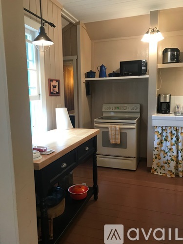 A kitchen with a stove, oven, and microwave.