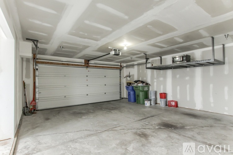 A spacious garage with a white ceiling and a white door.