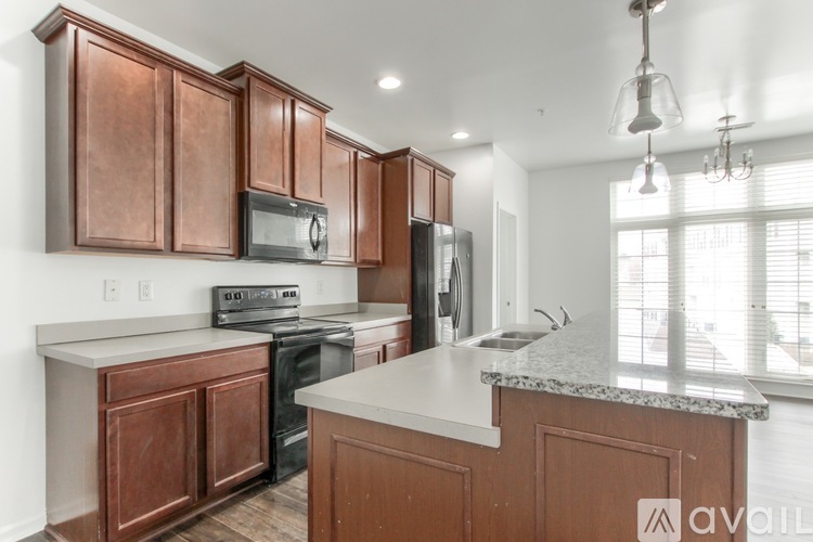A kitchen with wooden cabinets and a granite countertop.