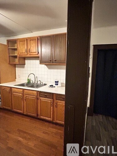 A kitchen with wooden cabinets and a white countertop.