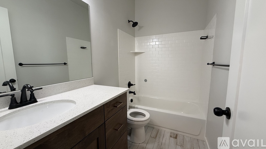 A bathroom with a toilet, sink, and bathtub.