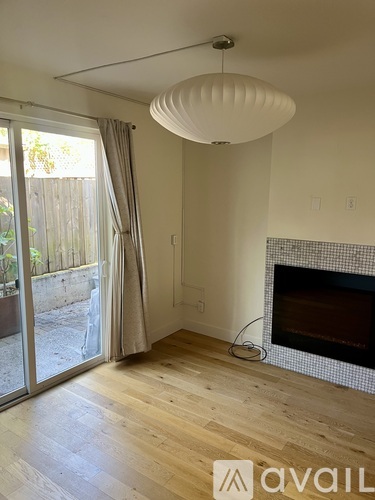 A living room with a fireplace and sliding glass doors.