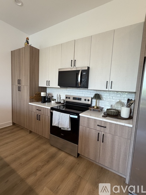 A kitchen with wooden cabinets and a black stove top.