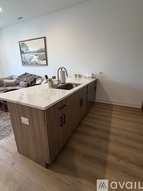 A kitchen with a sink and a fridge in it.