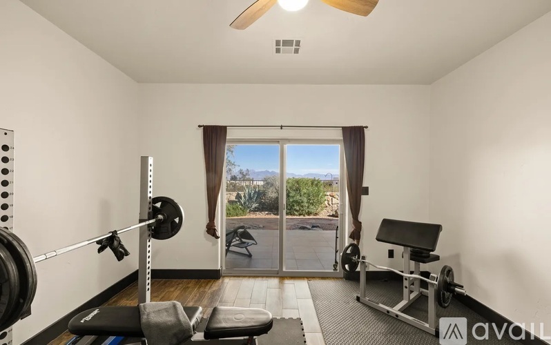 A home gym with a barbell and weight plates.
