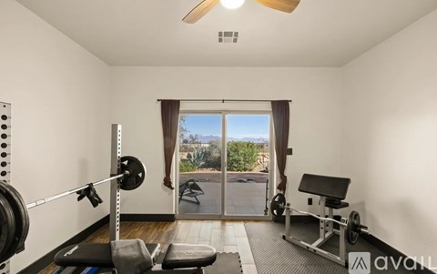 A home gym with a barbell and weight plates.