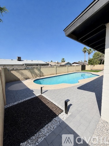A small pool with a black and white tile border.