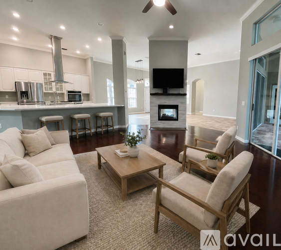 A living room with a white couch, a wooden coffee table, and a television.