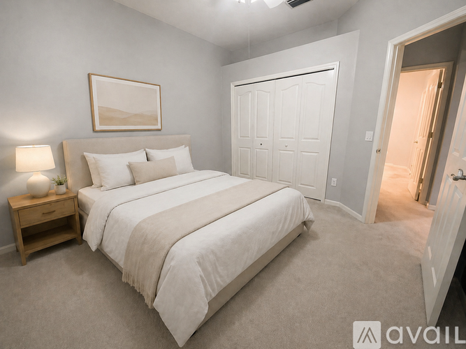 A bedroom with a large bed and a painting on the wall.