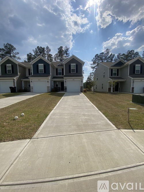 A row of houses with a walkway in the foreground.