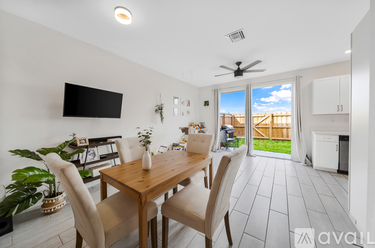 A dining room with a wooden table and chairs.