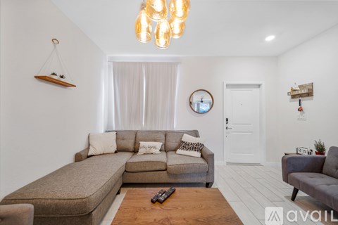 A living room with a grey couch and a wooden coffee table.