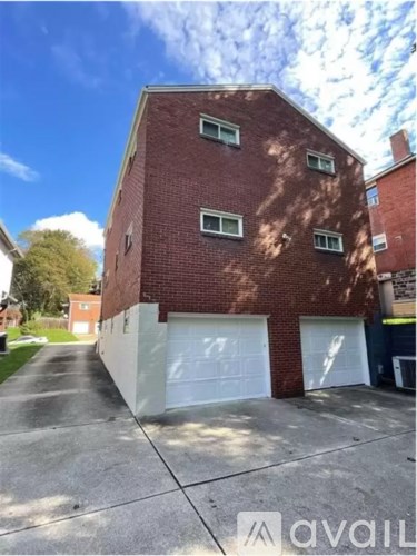 A red brick building with a white garage door.