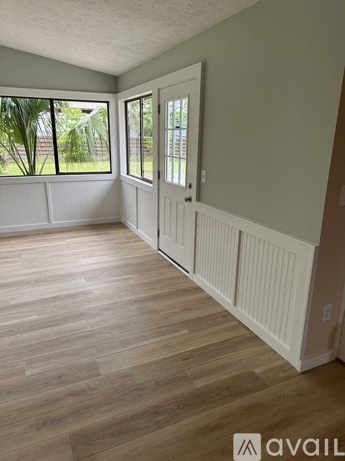 A room with light wood flooring and white trim.