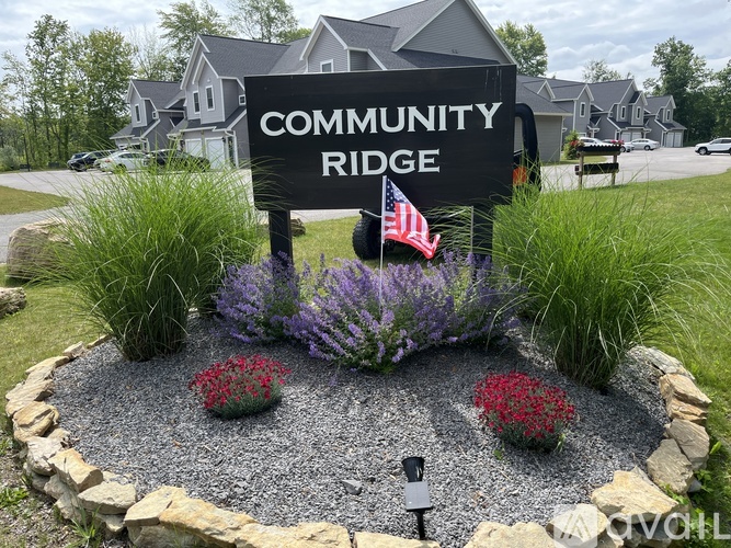 A sign that says Community Ridge in front of some houses.